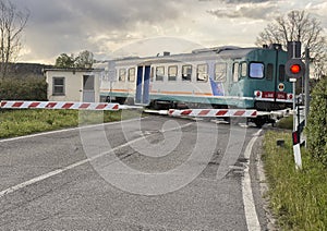Trenitalia diesel railcar ALn 668 crossing a road in Tuscany, Italy. photo