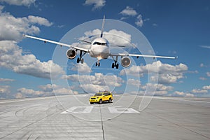 Treshold of runway with car and plane photo