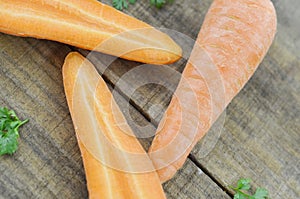 Triagle made of fresh carrots on wooden rustic