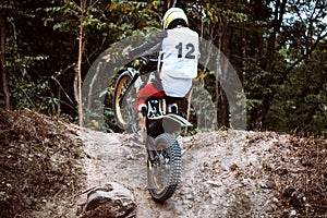 Trials motorcycle while competition in nature park