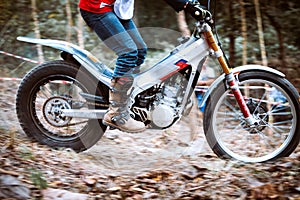 Trials motorcycle while competition in nature park