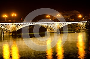 Triana Bridge illuminated at night