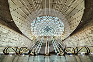 Triangeln Station entrance with escalators and glazed vault is empty due to the COVID outbreak Corona Virus or COVID19 pandemic