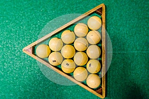 Triangle of balls on the green cloth. Russian billiard. Top view