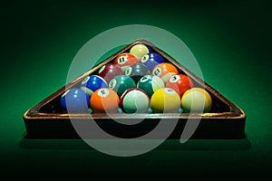 Triangle with billiard balls on green table