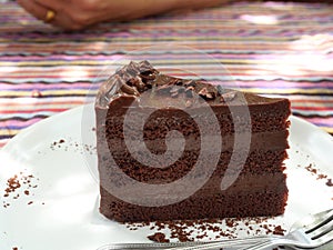 Triangle chocolate cake in dish on table