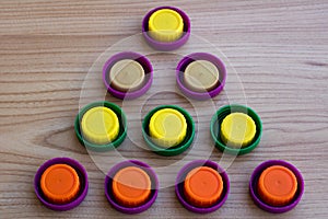 Triangle of colorful plastic lids