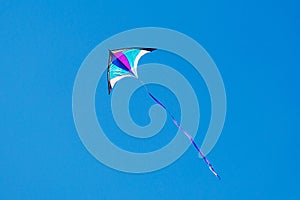 Triangle kite flying on a sunny day