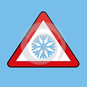 Triangle road sign with snowflake for cold winter photo