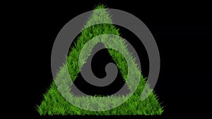 Triangle shape with green grass effect on plain black background