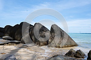 The triangular abstract rocks on white sand beach under fresh blue sky, Khao Saba beach, Phang Nga, Thailand