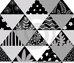 Triangular black and white patchwork with abstract branches, leaves and flowers.