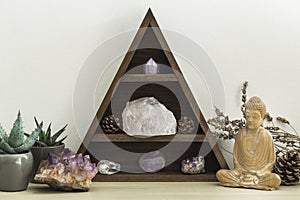 Triangular Crystal Shelf with Succulent Plants Foliage and Wooden Statue of Buddha