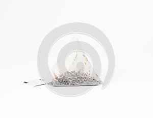 Triangular disposable tea bag on a rope, white background