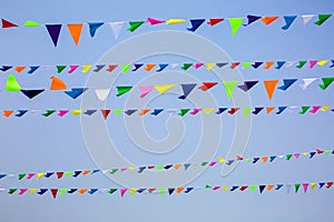 The triangular festive multi-colored flags.