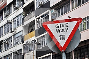 Triangular give way traffic warning board and 2 birds