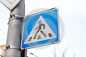 Triangular pedestrian crossing sign. Blue symbol for cars