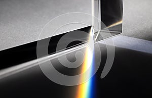 Triangular Prism dispersing sun beam splitting into a spectrum on white background