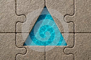 A triangular puzzle piece filled with water.