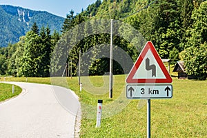 Triangular Road Sign of Winding Roads Ahead - Road with Dangerous Curves