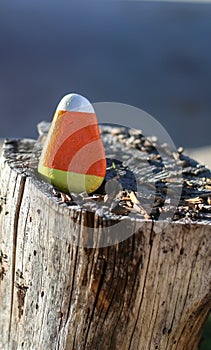 Triangular rock painted to look like candy corn