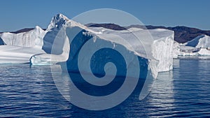 Triangular shaped iceberg with abrupt sides on a calm sea