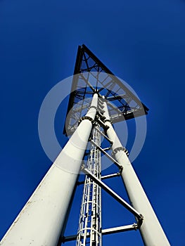 Triangular sign on a big three leg steel pole