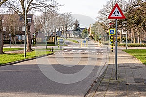 Triangular traffic sign for roundabout, pedestrian crossing, metal post with a triangular plate