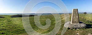 Triangulation point or station at the top of White Sheet Hill with beautiful panoramic views across the countryside in Wiltshire