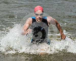 Triathlete comming out ot the water photo