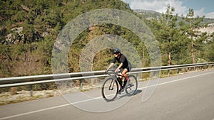 Triathlete cyclist training on bicycle. Sport recreation workout. Fit athlete woman cycling on bike, preparing for cycling triathl