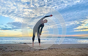 Triathlete man preparing to swim in the sea at sunrise