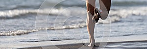Triathlete running into the sea