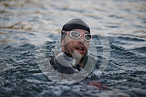 Triathlete swimmer having a break during hard training