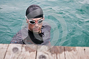 Triathlete swimmer portrait wearing wetsuit on training