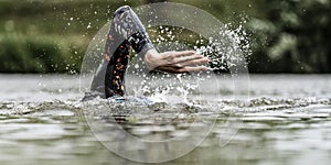 Triathlete swimming in a lake