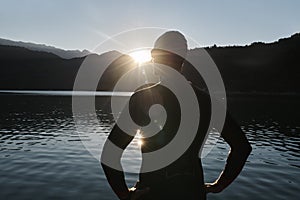 Triathlon athlete starting swimming training on lake