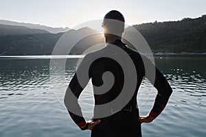 Triathlon athlete starting swimming training on lake