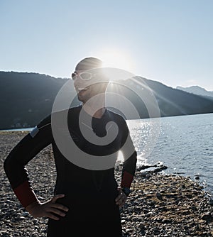 Triathlon athlete starting swimming training on lake