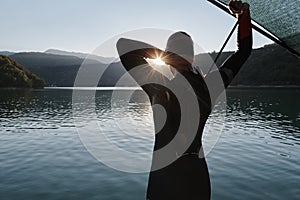 Triathlon athlete starting swimming training on lake