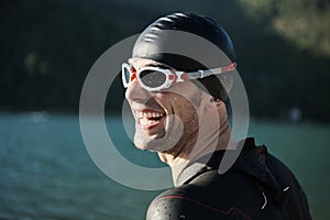 Triathlon athlete starting swimming training on lake