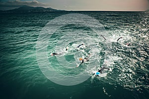 Triathlon swimmers train in open water