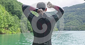 Triathlon swimming man - male triathlete swimmer portrait after ocean swim workout exercise session. Fit man in