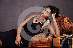 Tribal beauty. Studio portrait of an elegantly beautiful young woman reclining on a futon.
