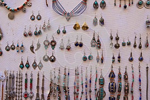 Tribal jewelery with colored stones for sale in a market in a souk in the Medina around the Jemaa el-Fnaa square in