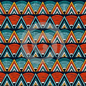 Tribal ornament in vibrant colours. Seamless abstract vector background.