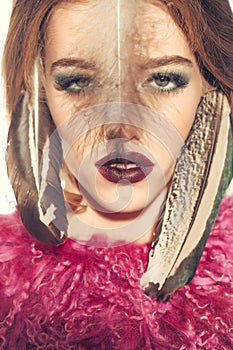 Tribal woman with feather closeup