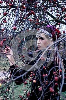 Tribal woman portrait outdoors in autumn trees