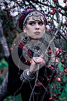 Tribal woman portrait outdoors in autumn trees