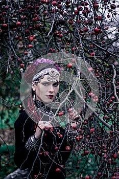 Tribal woman portrait outdoors in autumn trees